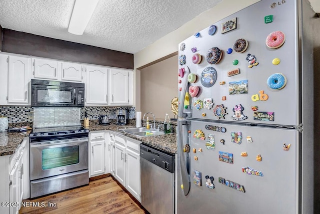 2120 Derringer Cir W, Jacksonville, FL 32225 - kitchen with stainless steel appliances, white cabinetry, a textured ceiling, and backsplash