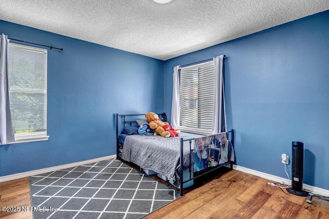 2120 Derringer Cir W, Jacksonville, FL 32225 - bedroom with wood finished floors and a textured ceiling