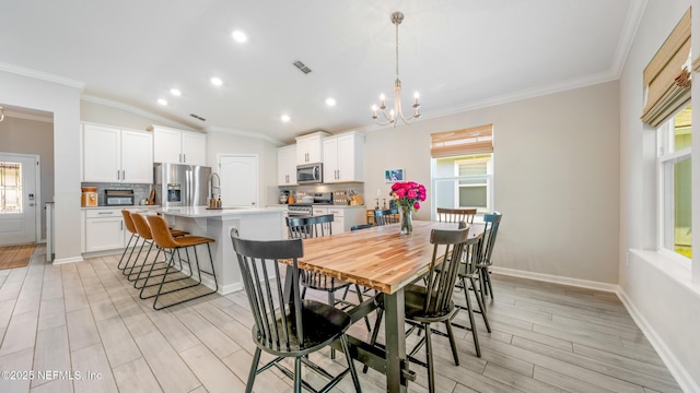 84 Granite City Ave, Saint Johns, FL 32259 - dining space featuring ornamental molding, lofted ceiling, a chandelier, light wood finished floors, and recessed lighting