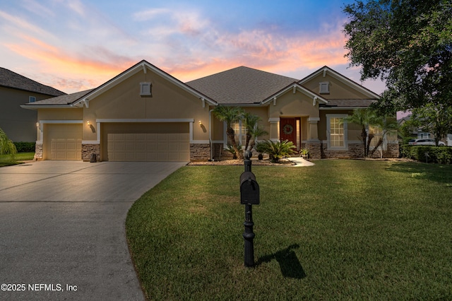 1100 Ashfield Way, Saint Johns, FL 32259 - view of front facade with stone siding, driveway, an attached garage, a yard, and stucco siding