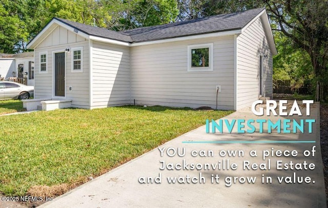 1588 W 15th St, Jacksonville, FL 32209 - view of side of home featuring a lawn, board and batten siding, and a shingled roof