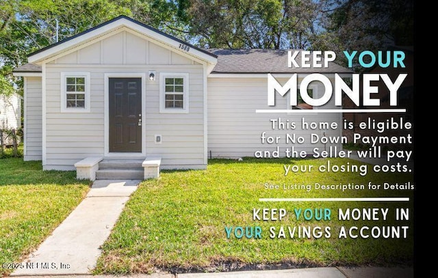 1588 W 15th St, Jacksonville, FL 32209 - view of front of home with board and batten siding, a front lawn, and a shingled roof