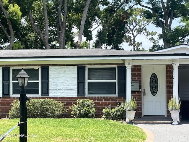 5713 Lake Lucina Dr N, Jacksonville, FL 32211 - entrance to property with brick siding and a yard