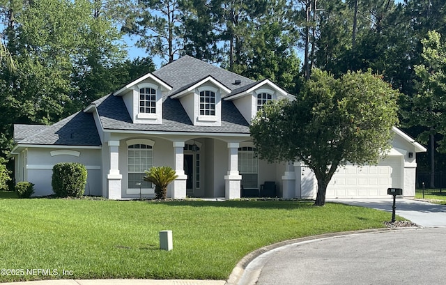 2506 Willow Creek Dr, Fleming Island, FL 32003 - view of front of house featuring a shingled roof, driveway, a garage, a front yard, and stucco siding