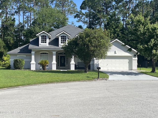 2506 Willow Creek Dr, Fleming Island, FL 32003 - view of front of house with driveway, roof with shingles, a front yard, a garage, and a porch