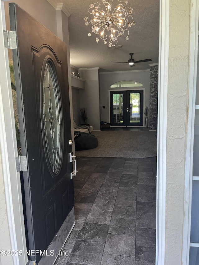 2506 Willow Creek Dr, Fleming Island, FL 32003 - entrance foyer featuring ornamental molding, a chandelier, a textured ceiling, dark carpet, and ceiling fan