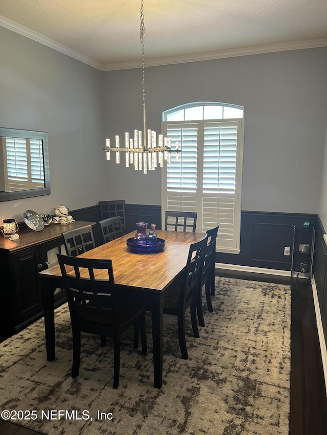 2506 Willow Creek Dr, Fleming Island, FL 32003 - dining area featuring ornamental molding, a chandelier, and wainscoting