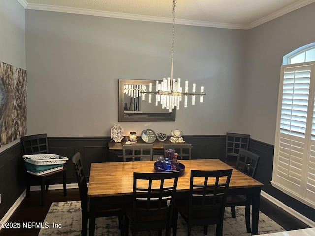 2506 Willow Creek Dr, Fleming Island, FL 32003 - dining room with wood finished floors, wainscoting, a chandelier, ornamental molding, and a decorative wall