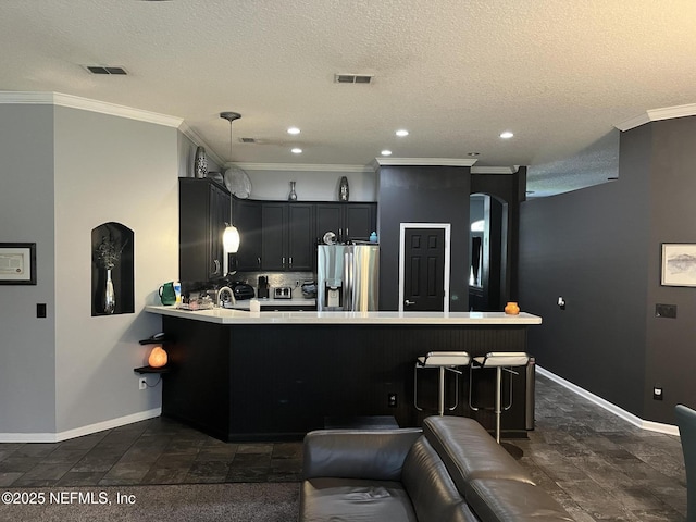 2506 Willow Creek Dr, Fleming Island, FL 32003 - kitchen featuring stainless steel fridge with ice dispenser, a peninsula, light countertops, ornamental molding, and recessed lighting