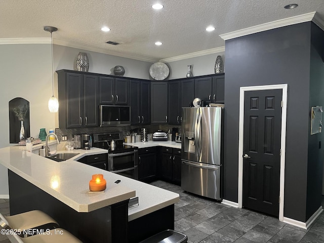 2506 Willow Creek Dr, Fleming Island, FL 32003 - kitchen with appliances with stainless steel finishes, a peninsula, light countertops, backsplash, and a kitchen breakfast bar