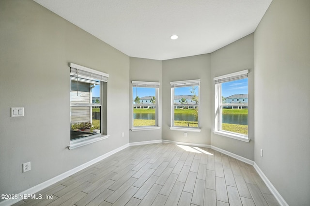63 Goldcrest Way, Saint Augustine, FL 32092 - spare room with healthy amount of natural light, wood finish floors, a water view, and recessed lighting