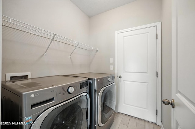 63 Goldcrest Way, Saint Augustine, FL 32092 - washroom with washing machine and clothes dryer and light wood-style floors