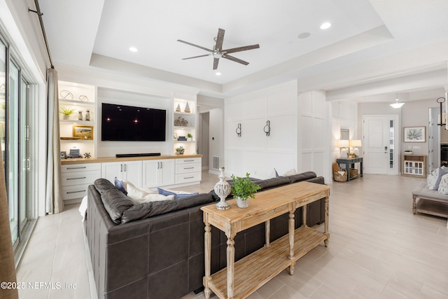 147 Rawlings Dr, Saint Johns, FL 32259 - living room with a tray ceiling, a ceiling fan, built in shelves, and recessed lighting