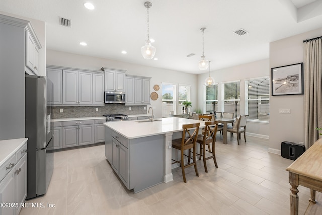 147 Rawlings Dr, Saint Johns, FL 32259 - kitchen with gray cabinetry, appliances with stainless steel finishes, backsplash, light countertops, and recessed lighting