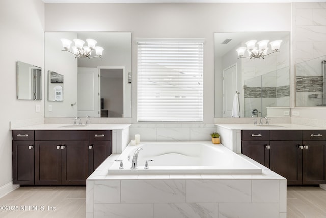 147 Rawlings Dr, Saint Johns, FL 32259 - bathroom with a chandelier, a stall shower, a bath, and two vanities