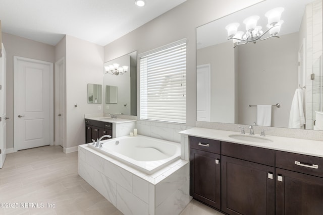 147 Rawlings Dr, Saint Johns, FL 32259 - full bathroom featuring a garden tub, a chandelier, two vanities, and a tile shower