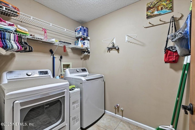 2282 Osceola Forest Ct, Fruit Cove, FL 32259 - laundry area with washer and dryer, light tile patterned floors, and a textured ceiling