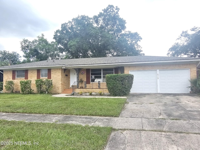 8348 Sanlando Ave, Jacksonville, FL 32211 - ranch-style home with brick siding, an attached garage, driveway, a front lawn, and covered porch
