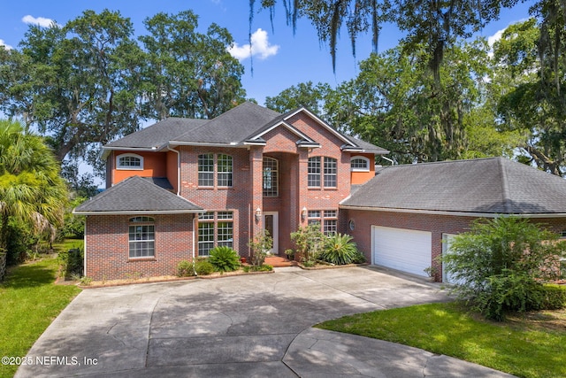 3305 US Highway 17, Fleming Island, FL 32003 - view of front of home with brick siding, concrete driveway, a garage, a front yard, and roof with shingles