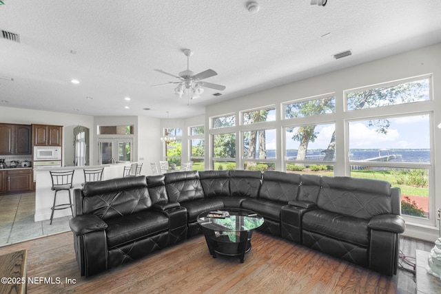 3305 US Highway 17, Fleming Island, FL 32003 - living room featuring plenty of natural light, a ceiling fan, a textured ceiling, recessed lighting, and light wood-style flooring