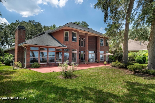 3305 US Highway 17, Fleming Island, FL 32003 - rear view of property with a chimney, a patio area, a yard, and brick siding