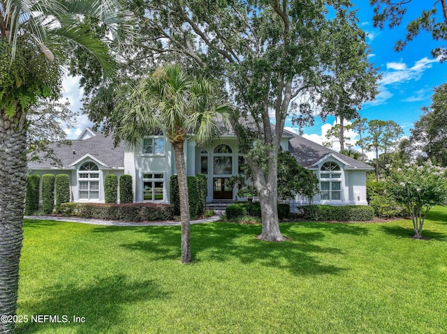 105 Teal Nest Ct, Ponte Vedra Beach, FL 32082 - obstructed view of property featuring a front yard, stucco siding, and a shingled roof