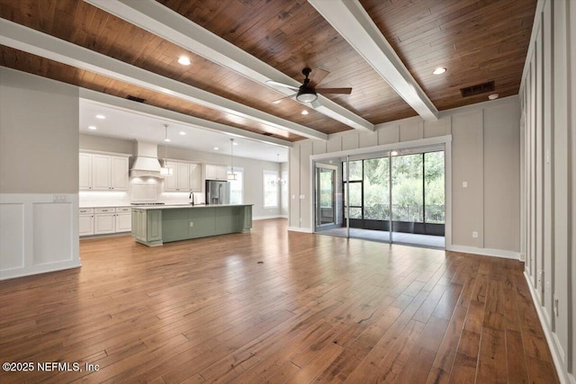305 Seahill Dr, Saint Augustine, FL 32092 - unfurnished living room with ceiling fan, wood finished floors, recessed lighting, a wooden ceiling with exposed beams, and a decorative wall