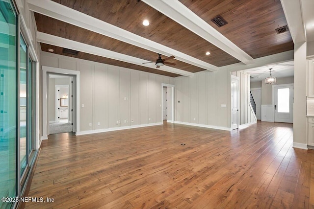 305 Seahill Dr, Saint Augustine, FL 32092 - unfurnished living room featuring hardwood / wood-style flooring, a ceiling fan, a wooden ceiling with exposed beams, and a decorative wall