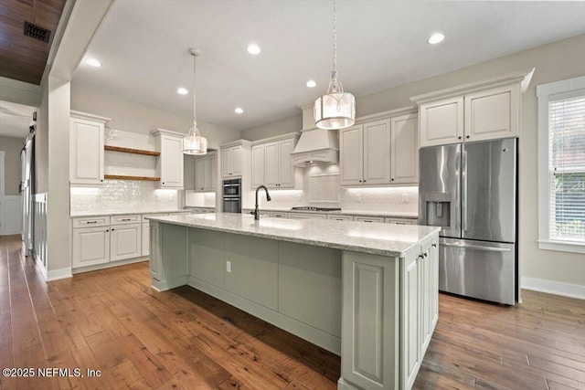 305 Seahill Dr, Saint Augustine, FL 32092 - kitchen featuring stainless steel fridge, open shelves, tasteful backsplash, light wood finished floors, and recessed lighting