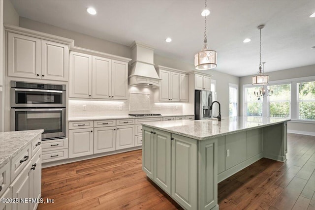 305 Seahill Dr, Saint Augustine, FL 32092 - kitchen featuring appliances with stainless steel finishes, recessed lighting, light wood finished floors, a kitchen island with sink, and tasteful backsplash