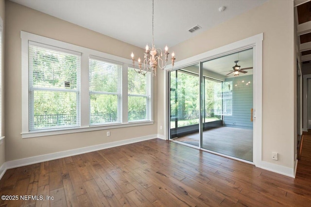 305 Seahill Dr, Saint Augustine, FL 32092 - unfurnished dining area with wood-type flooring, a chandelier, and ceiling fan
