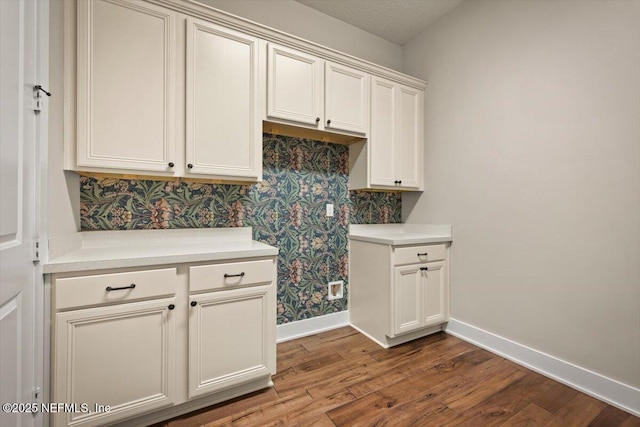 305 Seahill Dr, Saint Augustine, FL 32092 - kitchen with wallpapered walls, wood finished floors, light countertops, and white cabinets