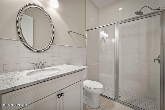 305 Seahill Dr, Saint Augustine, FL 32092 - full bath featuring tile walls, a shower stall, vanity, and tile patterned flooring