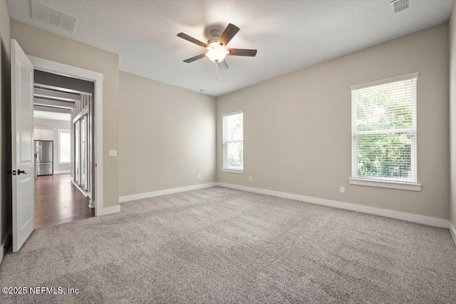 305 Seahill Dr, Saint Augustine, FL 32092 - spare room featuring carpet floors, a ceiling fan, and a textured ceiling