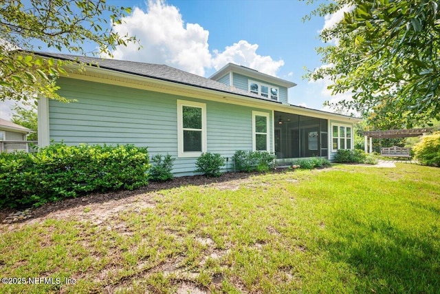 305 Seahill Dr, Saint Augustine, FL 32092 - rear view of house featuring a yard and a sunroom