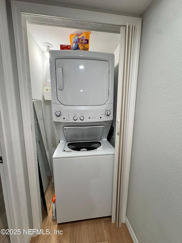 1618 El Camino Rd Unit 2, Jacksonville, FL 32216 - washroom with stacked washer / drying machine and wood finished floors