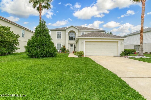76146 Long Leaf Loop, Yulee, FL 32097 - view of front of property with stucco siding, concrete driveway, an attached garage, a front lawn, and roof with shingles