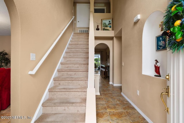 76146 Long Leaf Loop, Yulee, FL 32097 - staircase with arched walkways and baseboards