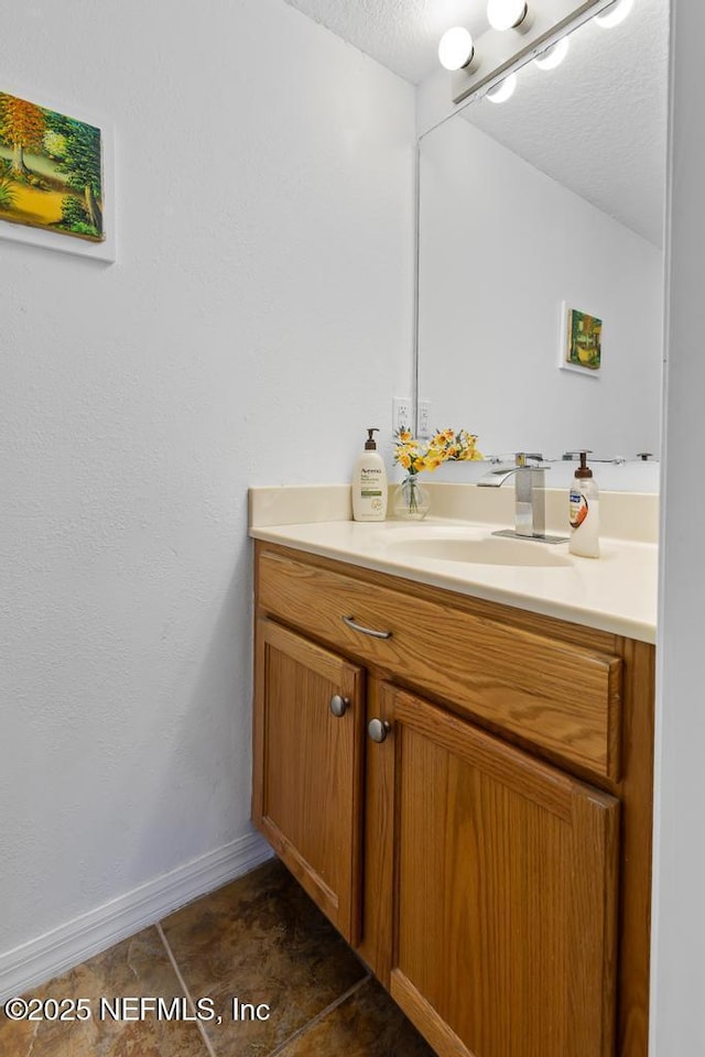 76146 Long Leaf Loop, Yulee, FL 32097 - bathroom featuring vanity, a textured ceiling, and tile patterned flooring