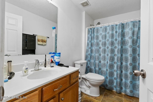76146 Long Leaf Loop, Yulee, FL 32097 - bathroom with vanity, a textured ceiling, stone finish floors, and curtained shower
