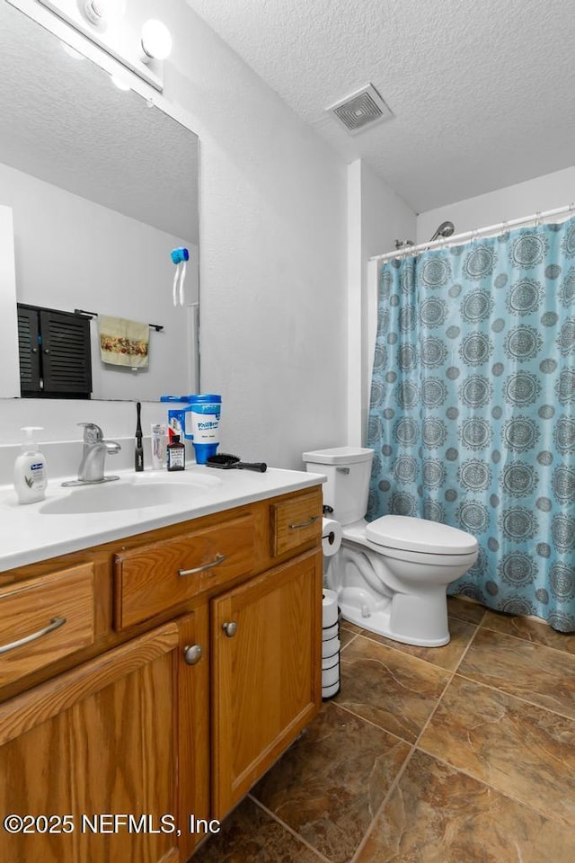 76146 Long Leaf Loop, Yulee, FL 32097 - full bathroom with vanity, a textured ceiling, and stone finish flooring