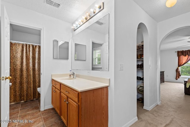 76146 Long Leaf Loop, Yulee, FL 32097 - bathroom with vanity, a textured ceiling, and curtained shower