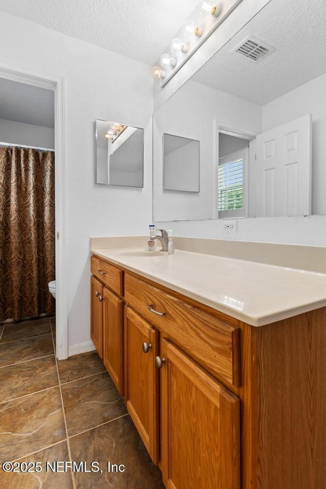 76146 Long Leaf Loop, Yulee, FL 32097 - bathroom with vanity and a textured ceiling