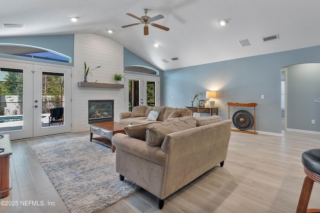 253 Bell Branch Ln, Saint Johns, FL 32259 - living room featuring french doors, ceiling fan, arched walkways, light wood-style floors, and high vaulted ceiling