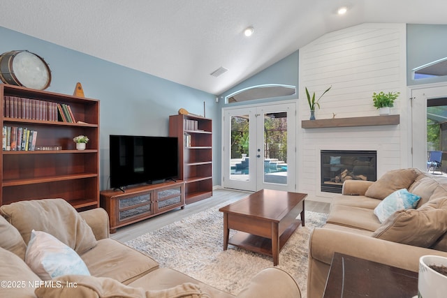 253 Bell Branch Ln, Saint Johns, FL 32259 - living room with vaulted ceiling, french doors, wood finished floors, healthy amount of natural light, and a textured ceiling