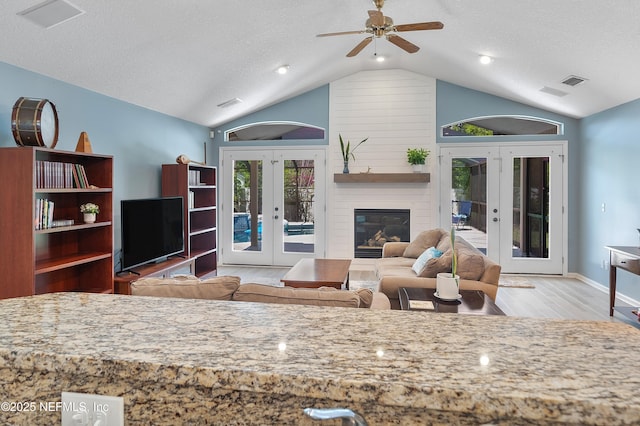 253 Bell Branch Ln, Saint Johns, FL 32259 - living area with french doors, vaulted ceiling, wood finished floors, a ceiling fan, and a textured ceiling