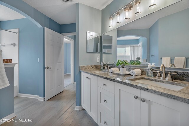 253 Bell Branch Ln, Saint Johns, FL 32259 - bathroom with double vanity and wood finished floors