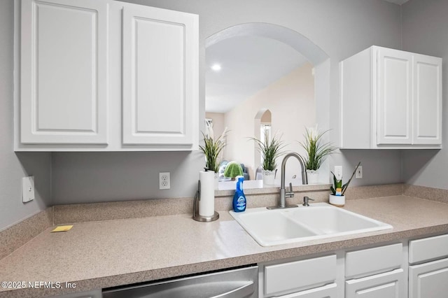 7990 Baymeadows Rd Unit 1003, Jacksonville, FL 32256 - kitchen featuring dishwasher, white cabinetry, arched walkways, and light countertops