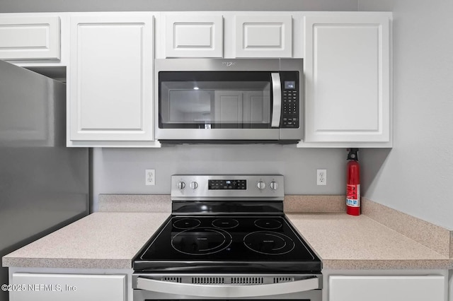 7990 Baymeadows Rd Unit 1003, Jacksonville, FL 32256 - kitchen with stainless steel appliances, white cabinetry, and light countertops