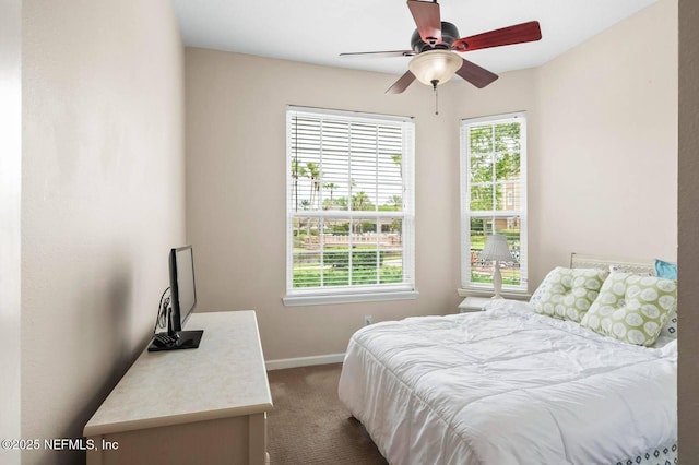 7990 Baymeadows Rd Unit 1003, Jacksonville, FL 32256 - bedroom with dark carpet, multiple windows, and a ceiling fan